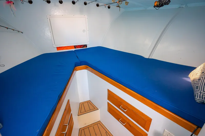 Moby Yacht Photos Pics Interior cabin of 1987 Custom Carolina Island Boatworks 34 Express with blue bedding.