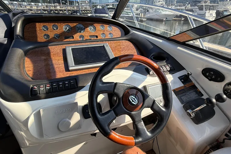  Yacht Photos Pics Helm of 2002 Sunseeker Camargue 44 yacht with wooden dashboard and steering wheel.