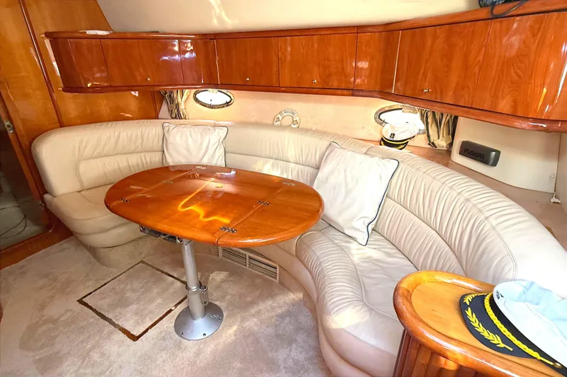  Yacht Photos Pics Luxurious interior of 2002 Sunseeker Camargue 44 yacht with leather seating and wooden table.