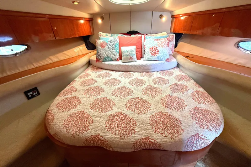  Yacht Photos Pics Luxurious 2002 Sunseeker Camargue 44 cabin with coral-themed bedding and elegant wood accents.
