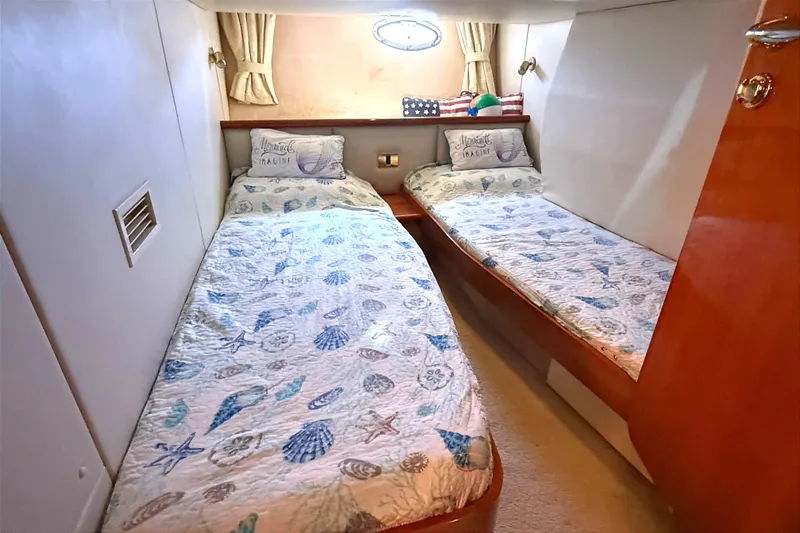  Yacht Photos Pics Twin cabin in 2002 Sunseeker Camargue 44 yacht with nautical-themed bedding.