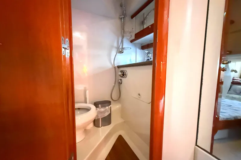  Yacht Photos Pics Bathroom interior of 2002 Sunseeker Camargue 44 yacht, featuring shower and toilet.