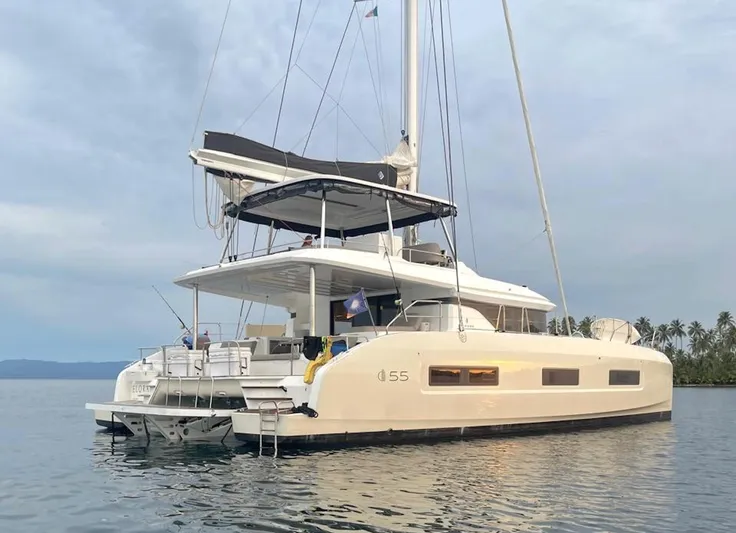 Elora Yacht Photos Pics 2023 Lagoon 55 yacht on calm water, featuring modern design and spacious deck.