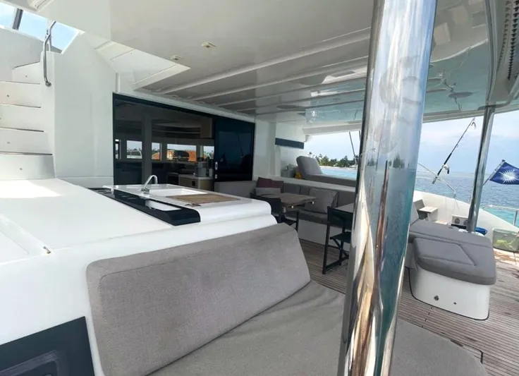 Elora Yacht Photos Pics Luxurious 2023 Lagoon 55 yacht interior with modern seating and ocean view.