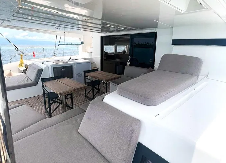 Elora Yacht Photos Pics Luxurious 2023 Lagoon 55 yacht interior with comfortable seating and ocean view.