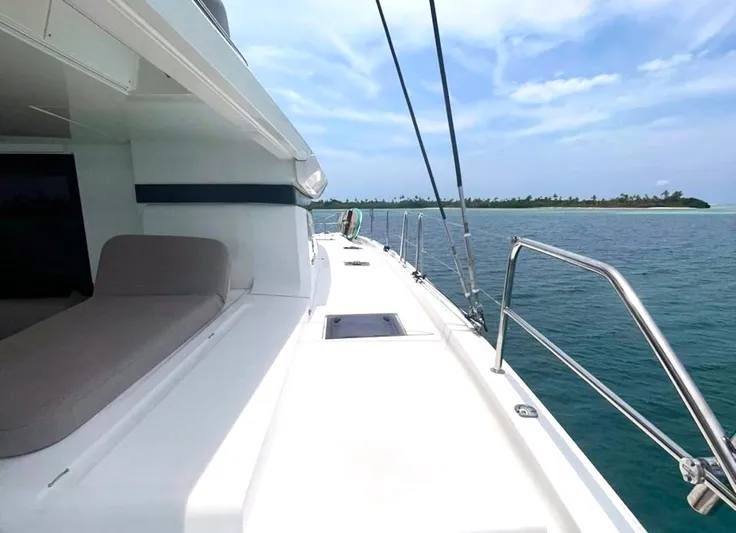 Elora Yacht Photos Pics 2023 Lagoon 55 yacht deck with ocean view and distant island.