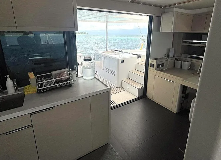 Elora Yacht Photos Pics Modern kitchen interior on 2023 Lagoon 55 yacht with ocean view.