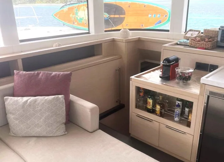 Elora Yacht Photos Pics Luxurious Lagoon 55 yacht interior with modern kitchenette and cozy seating, 2023 model.