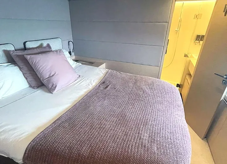 Elora Yacht Photos Pics Luxurious bedroom interior of 2023 Lagoon 55 yacht with cozy bedding and modern design.