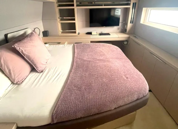 Elora Yacht Photos Pics Luxurious bedroom interior of 2023 Lagoon 55 yacht with cozy bedding and modern decor.