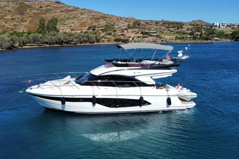  Yacht Photos Pics Luxury 2023 Princess F45 yacht cruising on serene blue waters.