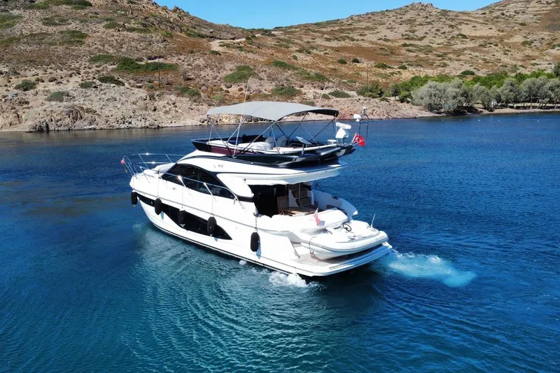  Yacht Photos Pics Luxury 2023 Princess F45 yacht cruising in scenic coastal waters.