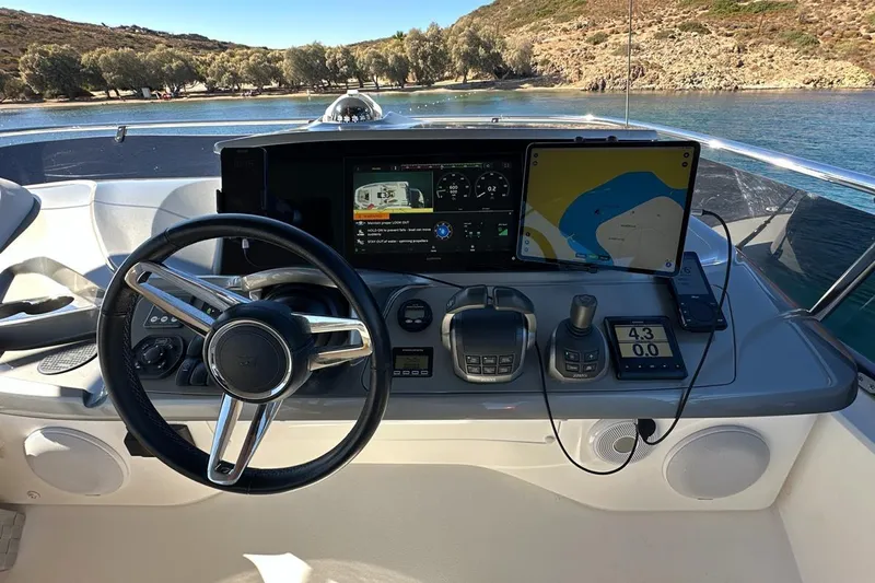  Yacht Photos Pics Cockpit of 2023 Princess F45 yacht with navigation screens and steering wheel.