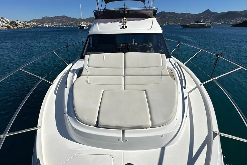  Yacht Photos Pics 2023 Princess F45 yacht with sunbed, cruising on a serene blue sea.