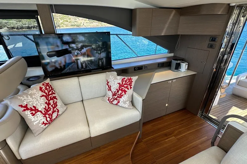  Yacht Photos Pics Luxurious 2023 Princess F45 yacht interior with elegant seating, decorative pillows, and scenic ocean view.