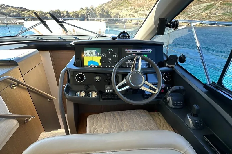  Yacht Photos Pics 2023 Princess F45 yacht helm with modern navigation system and scenic ocean view.