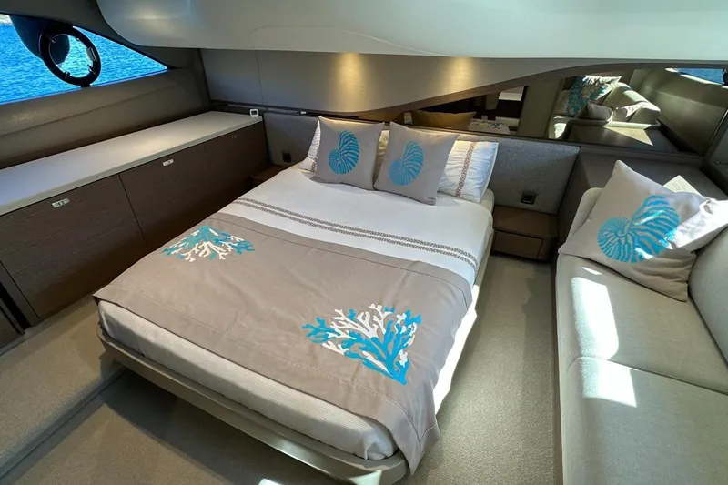  Yacht Photos Pics Luxurious bedroom interior of 2023 Princess F45 yacht with elegant bedding and ocean view.