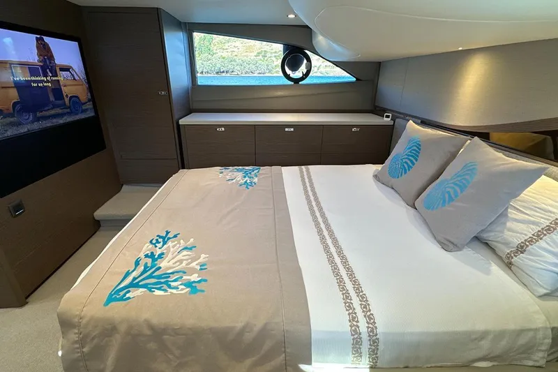  Yacht Photos Pics Luxurious bedroom interior of 2023 Princess F45 yacht with elegant bedding and modern design.