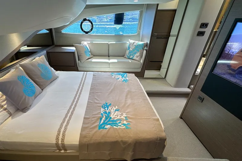  Yacht Photos Pics Luxurious interior of 2023 Princess F45 yacht with elegant bedding and seating area.