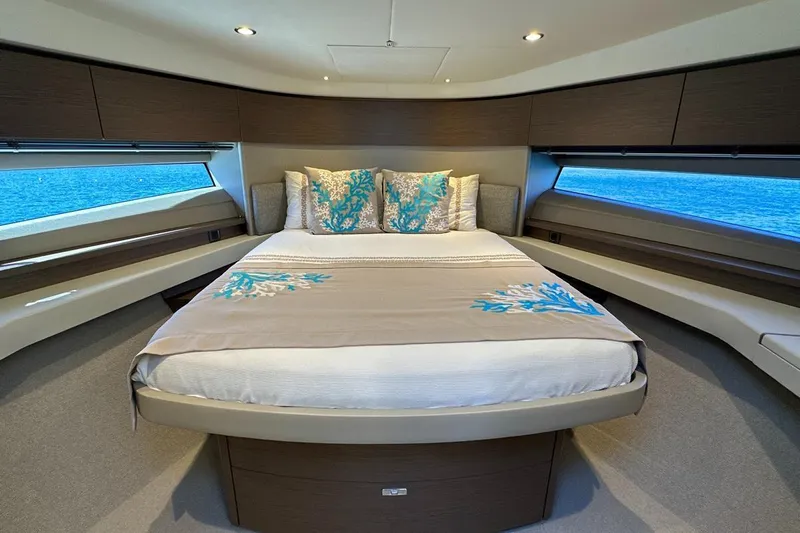  Yacht Photos Pics Luxurious bedroom interior of 2023 Princess F45 yacht with elegant bedding and ocean view.