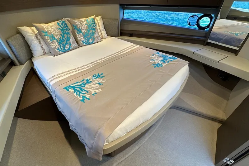  Yacht Photos Pics Luxurious bedroom interior of 2023 Princess F45 yacht with elegant bedding and sea view.