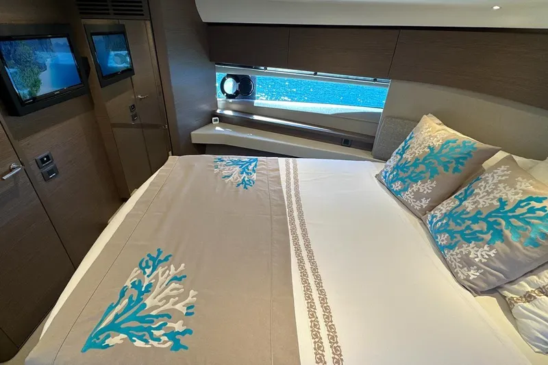  Yacht Photos Pics Luxurious bedroom interior of 2023 Princess F45 yacht with elegant bedding and ocean view.
