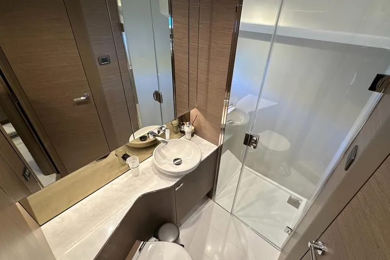  Yacht Photos Pics Modern bathroom in 2023 Princess F45 yacht with sleek design and glass shower.