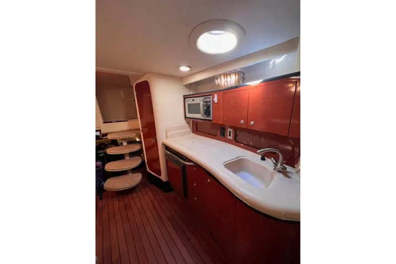  Yacht Photos Pics 2005 Sea Ray Sundancer 320 interior kitchen with wooden cabinets and modern appliances.