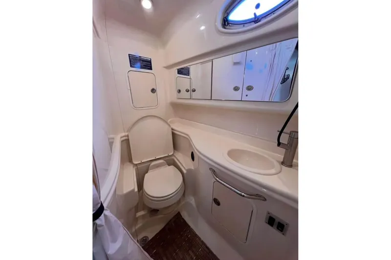  Yacht Photos Pics 2005 Sea Ray Sundancer 320 bathroom with toilet, sink, and storage cabinets.