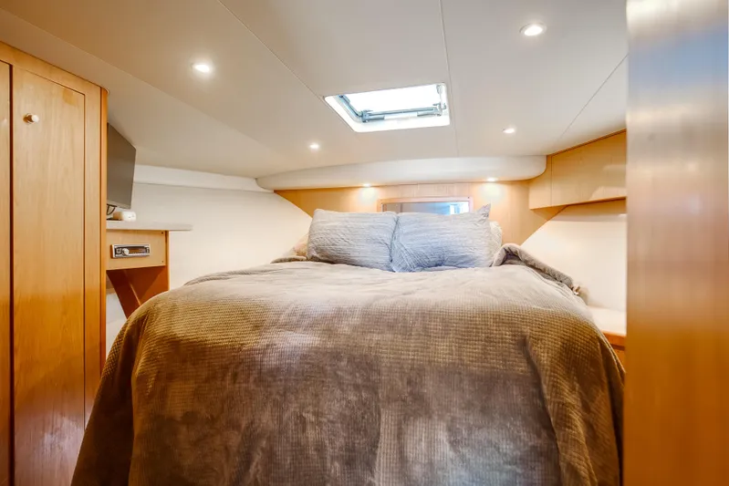 Jenn-a Yacht Photos Pics Luxurious cabin interior of 2007 Luhrs Tournament 360 Open yacht with cozy bedding.