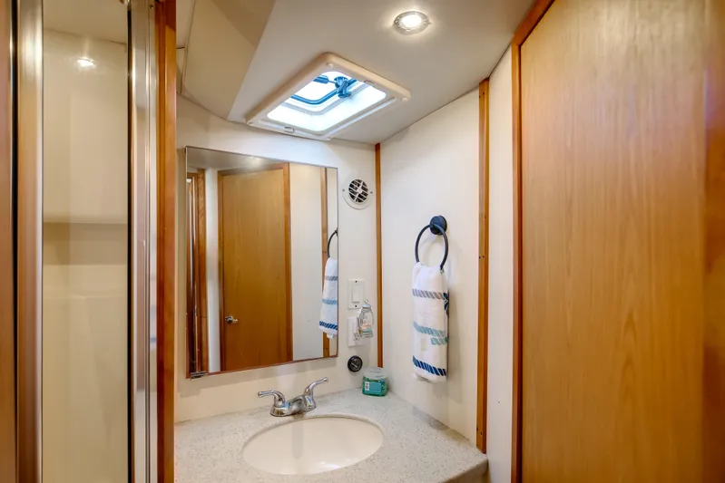 Jenn-a Yacht Photos Pics Bathroom interior of 2007 Luhrs Tournament 360 Open boat, featuring sink and mirror.