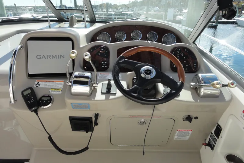  Yacht Photos Pics 2007 Sea Ray 320 Sundancer helm with Garmin navigation, steering wheel, and control panel.