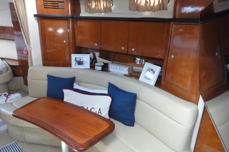  Yacht Photos Pics Luxurious interior of 2007 Sea Ray 320 Sundancer with elegant wood cabinetry and cozy seating.
