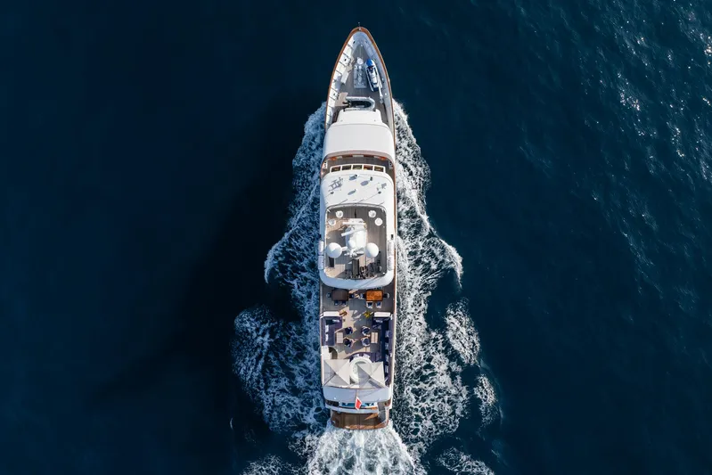 Synthesis 66 Yacht Photos Pics Aerial view of 1982 Feadship yacht cruising on open water.