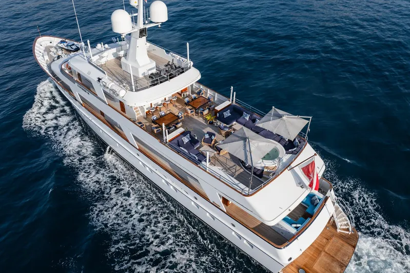 Synthesis 66 Yacht Photos Pics Luxurious 1982 Feadship yacht cruising on open sea, featuring spacious decks and elegant design.