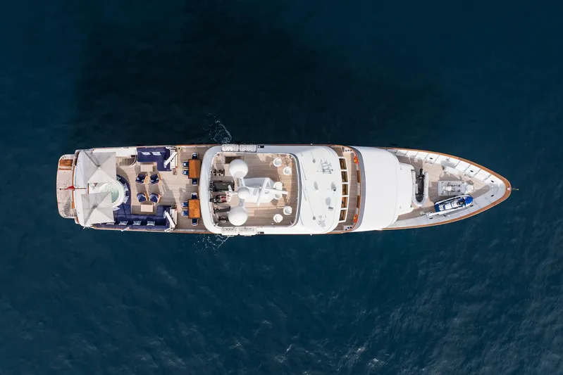 Synthesis 66 Yacht Photos Pics Aerial view of 1982 Feadship yacht on open water, showcasing luxurious deck layout.