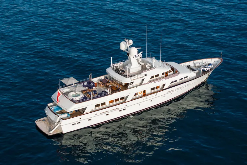 Synthesis 66 Yacht Photos Pics Luxurious 1982 Feadship yacht cruising on open sea, aerial view.