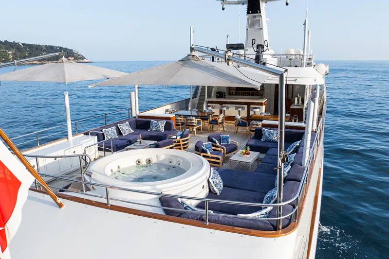 Synthesis 66 Yacht Photos Pics Luxurious 1982 Feadship yacht deck with jacuzzi, seating, and ocean view.