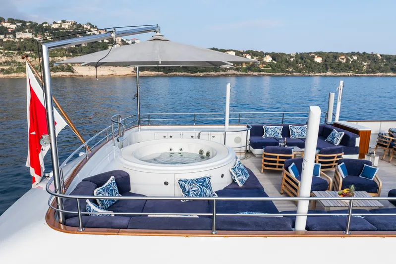 Synthesis 66 Yacht Photos Pics Luxurious 1982 Feadship yacht deck with jacuzzi, seating, and ocean view.