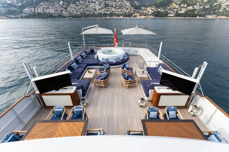 Synthesis 66 Yacht Photos Pics Luxurious 1982 Feadship yacht deck with seating, hot tub, and scenic ocean view.