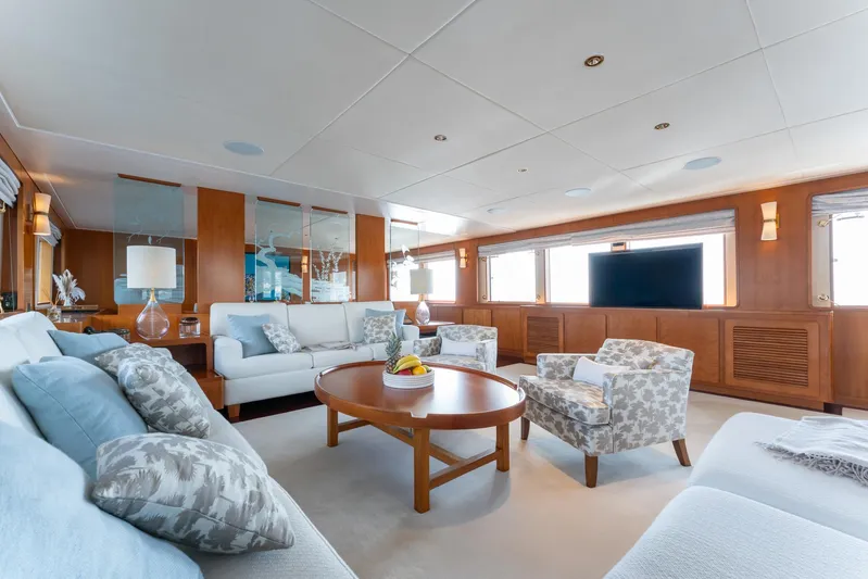 Synthesis 66 Yacht Photos Pics Luxurious yacht interior with elegant seating, wooden accents, and large windows, Feadship 1982 model.