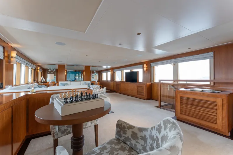 Synthesis 66 Yacht Photos Pics Luxurious 1982 Feadship yacht interior with elegant wood paneling and chess set.