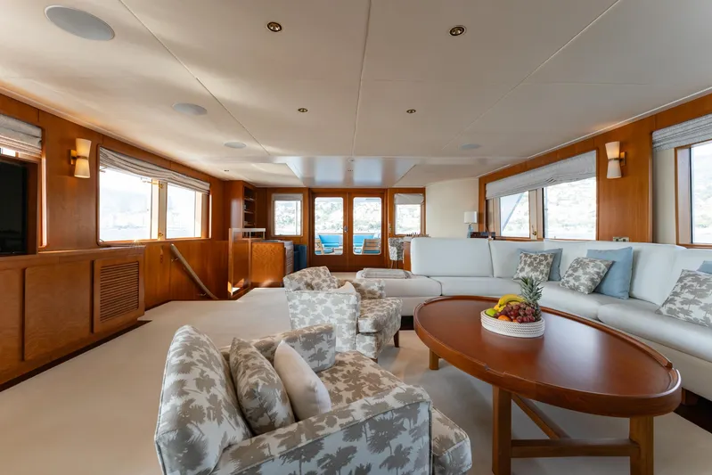 Synthesis 66 Yacht Photos Pics Luxurious 1982 Feadship yacht interior with elegant seating, wooden accents, and large windows.