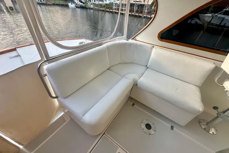Seaquell Yacht Photos Pics White cushioned seating area on 2005 Legacy Yachts 34 Express, overlooking marina.