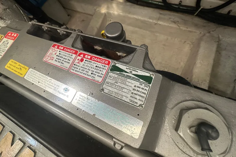 Seaquell Yacht Photos Pics Engine compartment of 2005 Legacy Yachts 34 Express with safety warning labels.