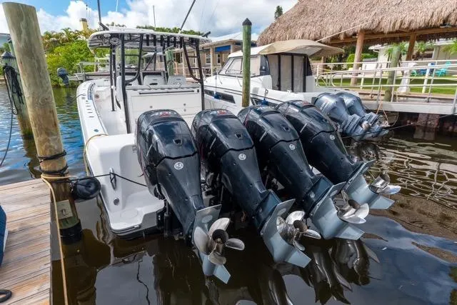  Yacht Photos Pics 2020 Contender 44 ST boat with four powerful outboard engines docked at marina.