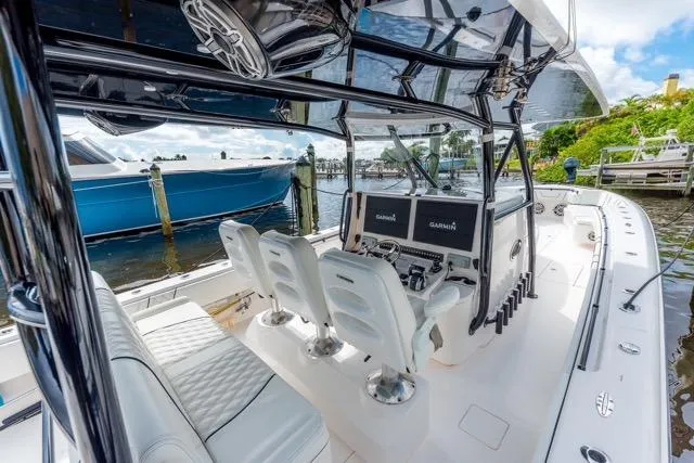  Yacht Photos Pics 2020 Contender 44 ST boat interior with helm, seating, and navigation equipment at dock.