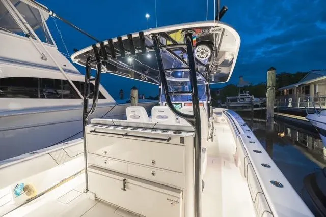  Yacht Photos Pics 2020 Contender 44 ST boat interior with illuminated deck at marina during twilight.