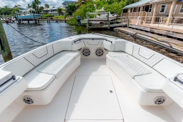  Yacht Photos Pics 2020 Contender 44 ST boat interior with white seating and waterfront view.