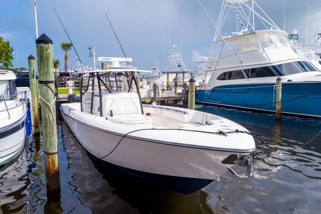  Yacht Photos Pics 2020 Contender 44 ST boat docked at marina, surrounded by other vessels.